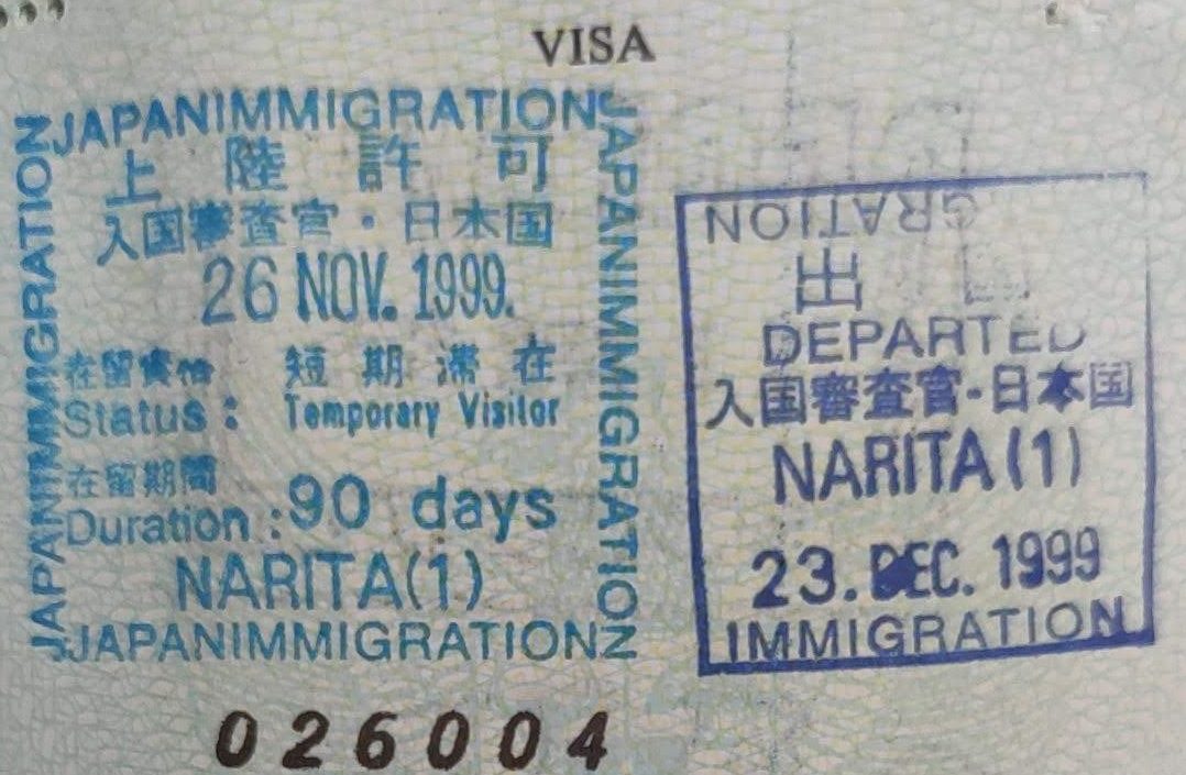 Japanese immigration landing permission and departure stamps in a passport