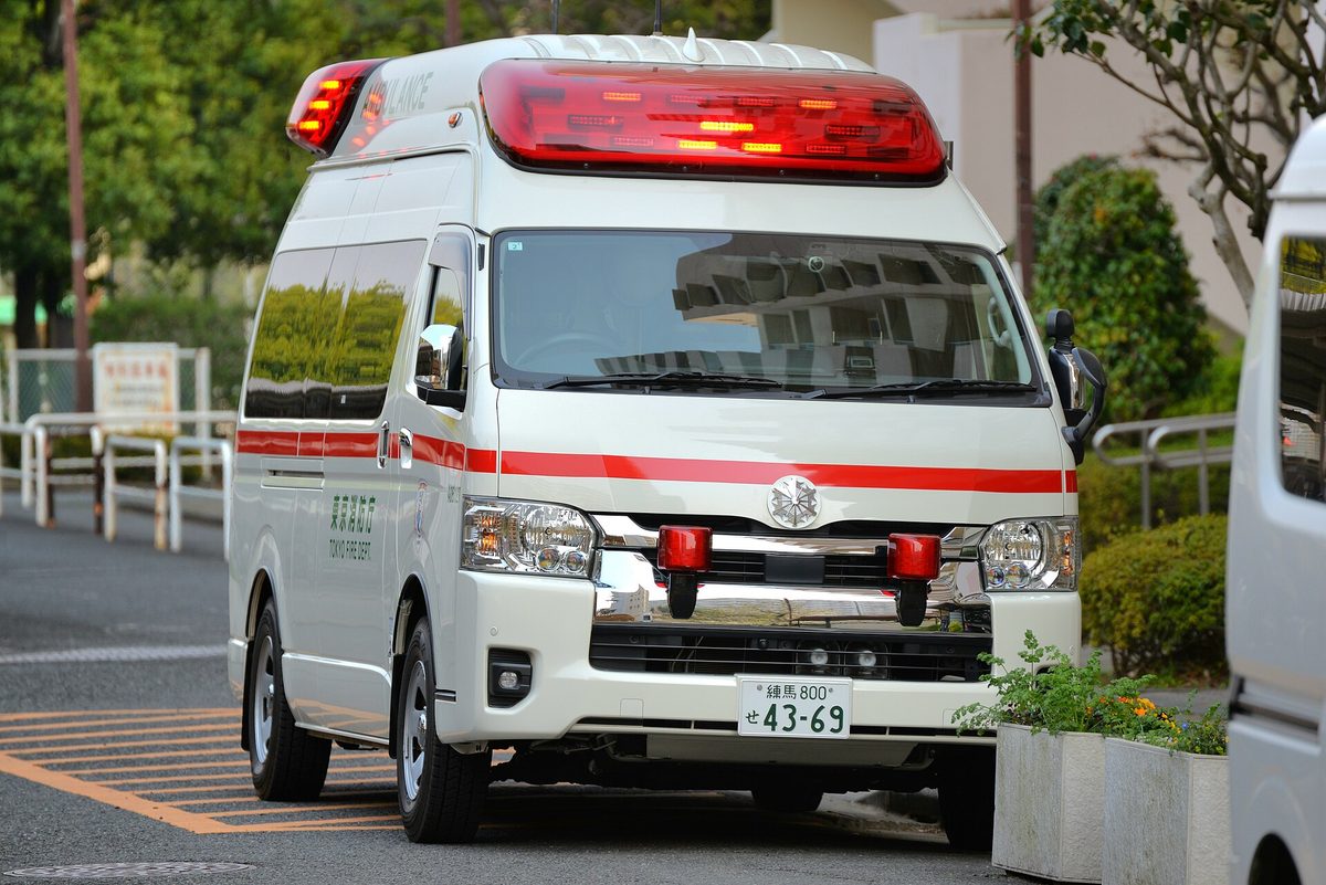A white Japanese ambulance with red stripes