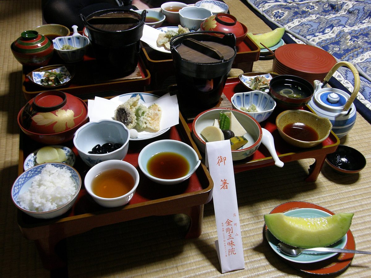 A shojin ryori meal of small dishes on lacquered trays at a temple lodging in Koyasan