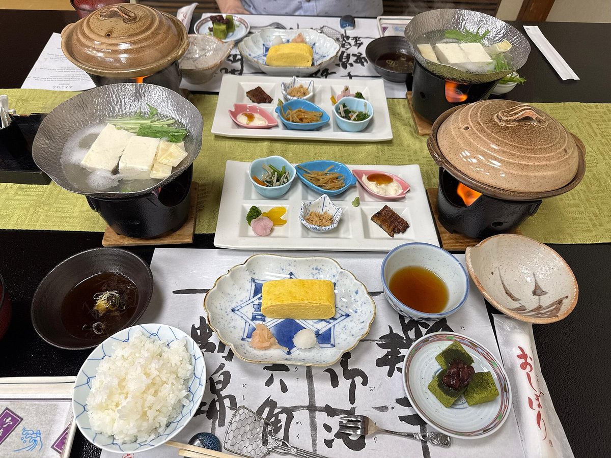 A Japanese breakfast at a ryokan: simmered tofu, rolled omelette, rice, fish and small side dishes
