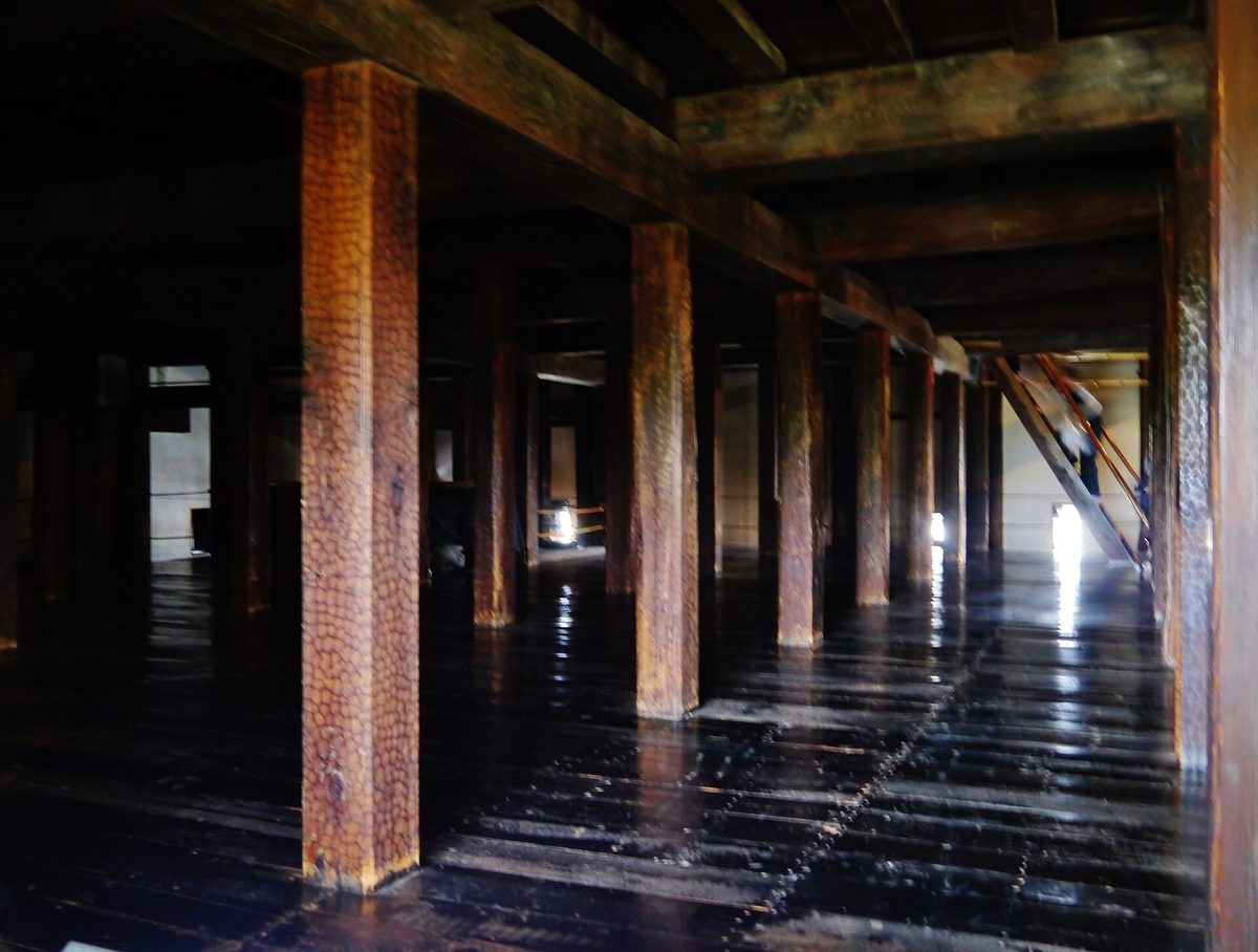 Dark wooden pillars and polished floorboards inside the keep of Matsumoto Castle, Matsumoto (Nagano)