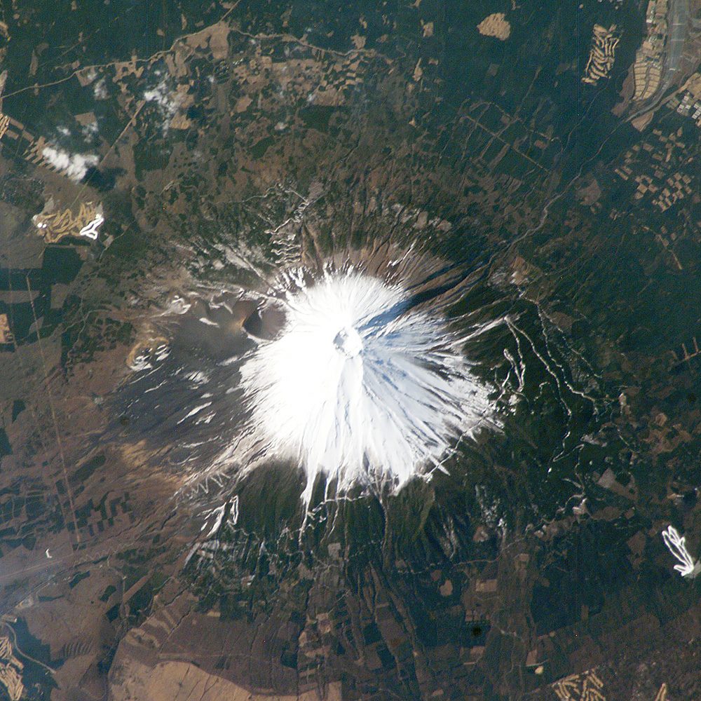 Mt. Fuji seen from space in late February, its upper slopes covered in snow