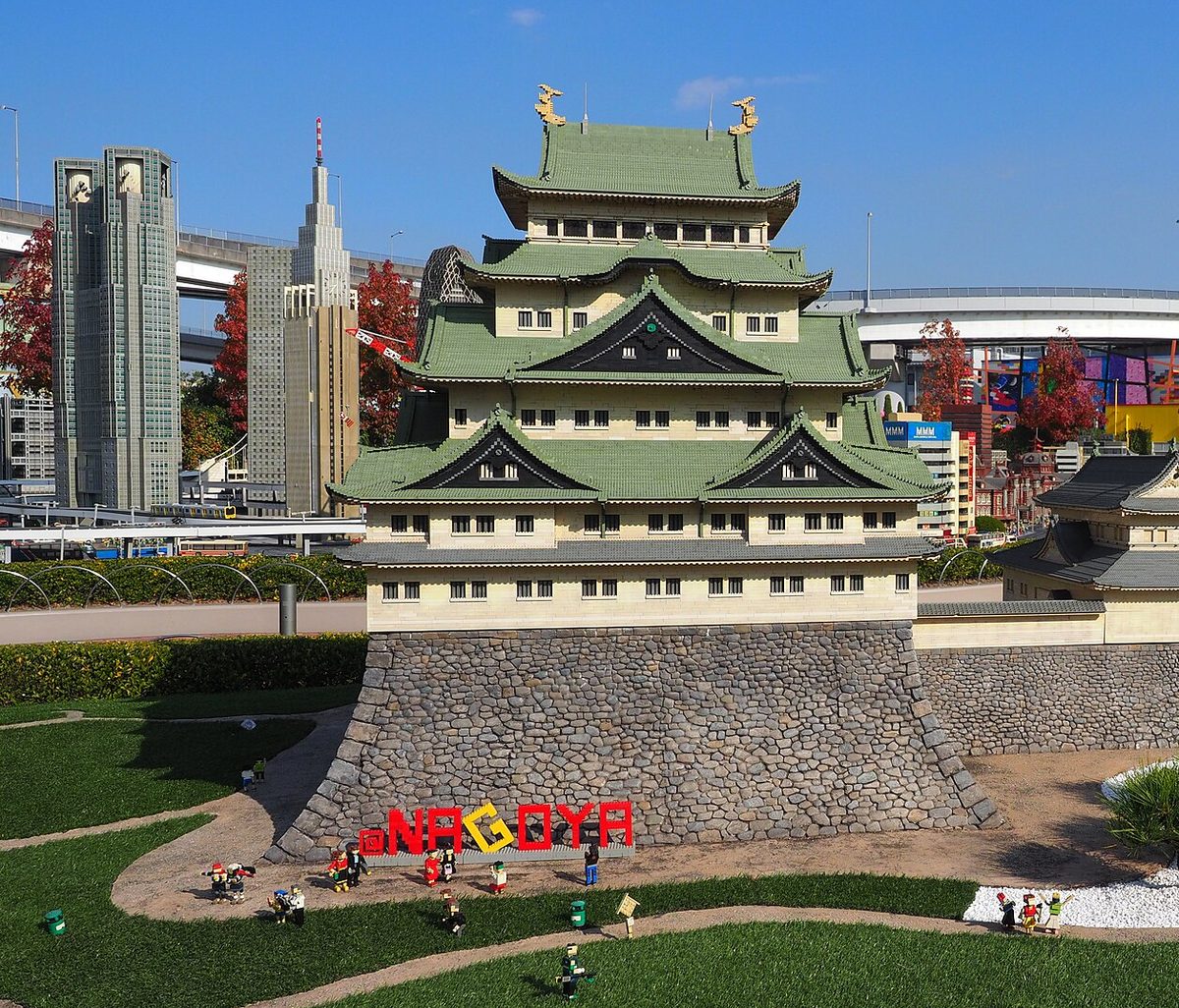 Nagoya Castle built in LEGO bricks in Miniland at LEGOLAND Japan, with green roofs and stone walls under a blue sky