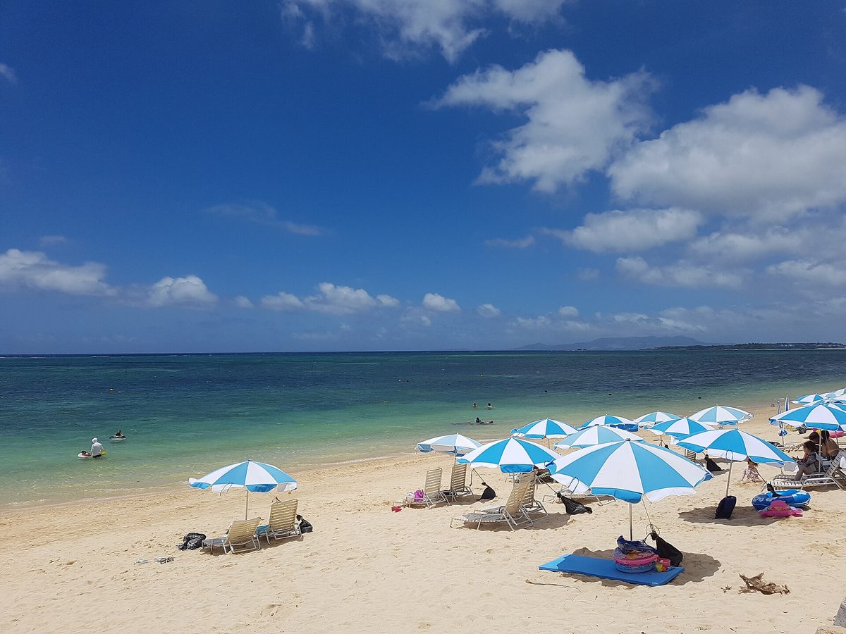 Beach umbrellas on a white sand beach in Okinawa