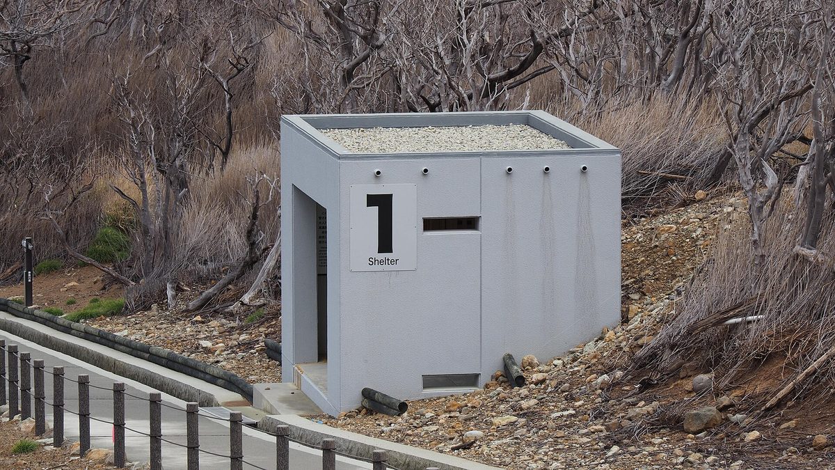 A small concrete shelter numbered 1 beside a path at Owakudani in Hakone (Kanagawa)