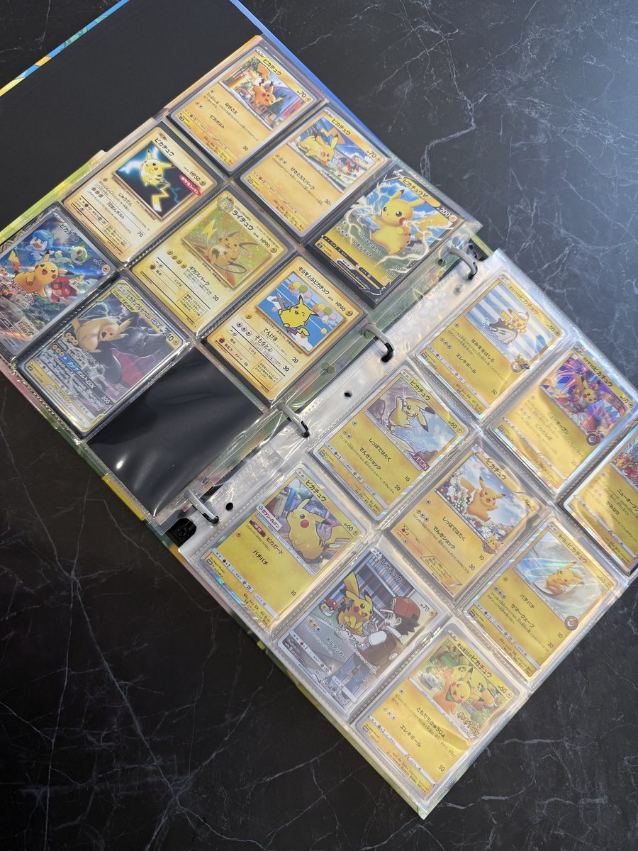 Two open binder pages full of Japanese Pikachu cards