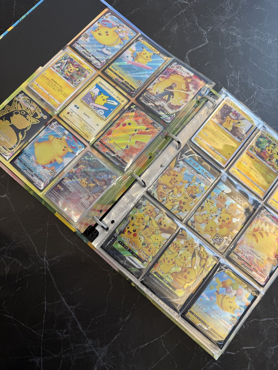 An open binder with clear pocket pages holding many Japanese Pikachu cards, one card in each pocket