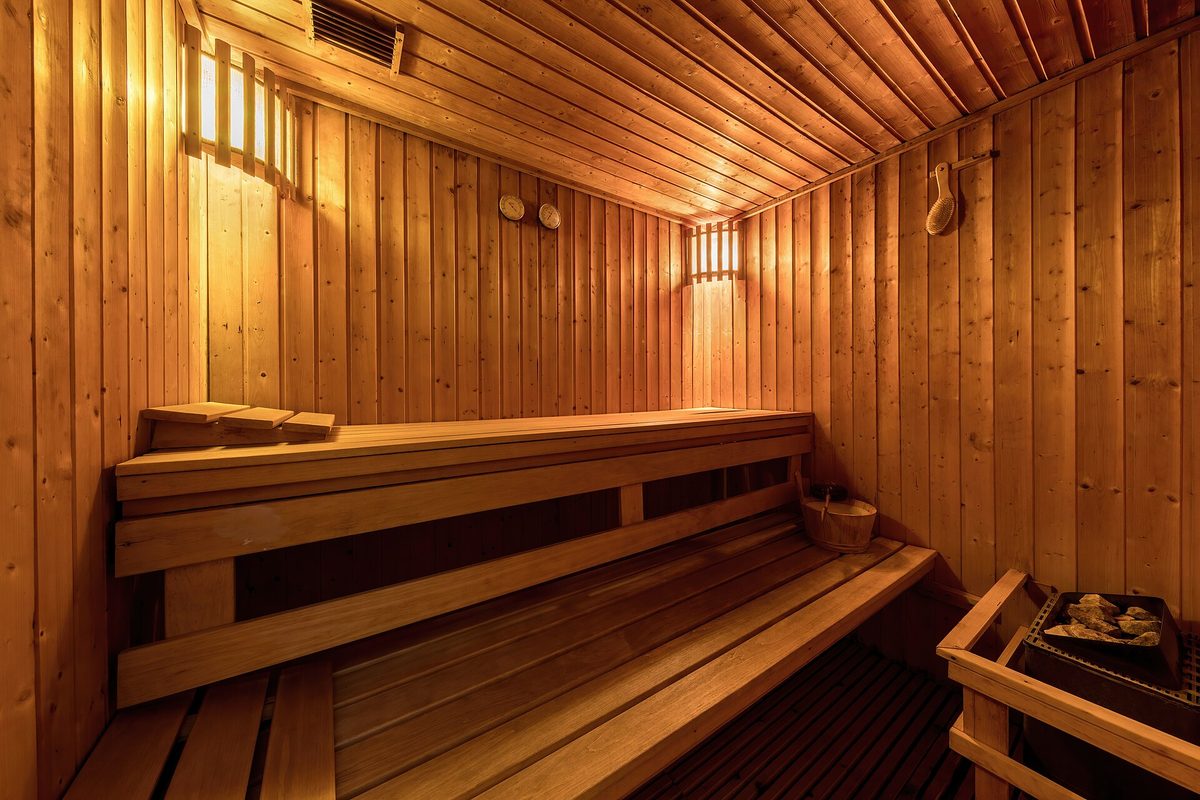 An empty wooden sauna room with tiered benches