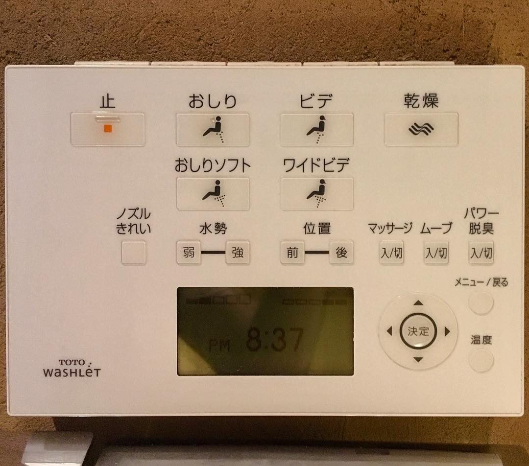 A wall-mounted bidet toilet control panel with buttons for stop, rear wash, bidet and drying