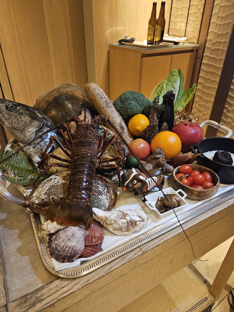 A wagon of fresh seasonal ingredients including spiny lobster, shellfish, vegetables and fruit