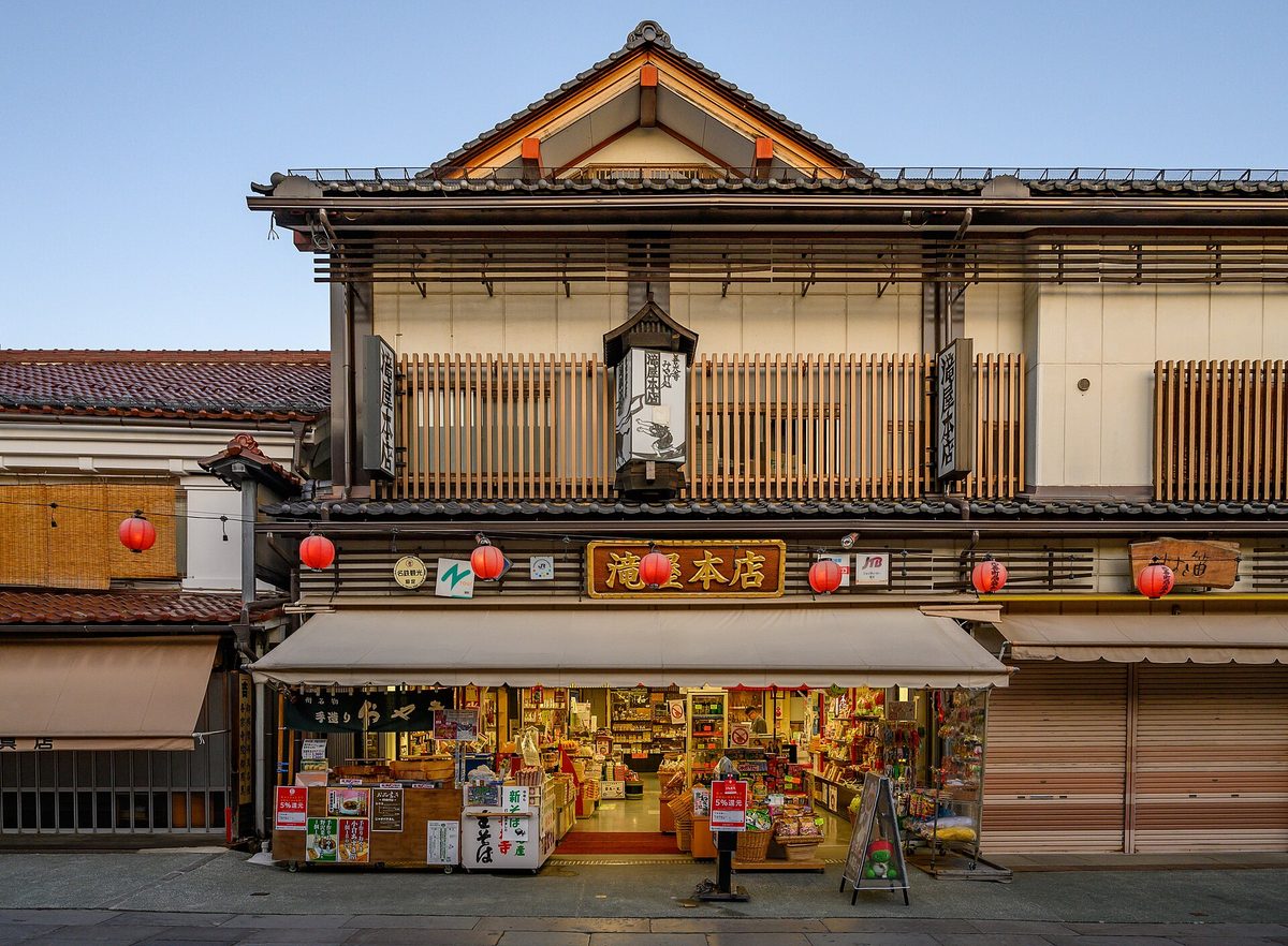 A traditional wooden souvenir shop with goods displayed out front