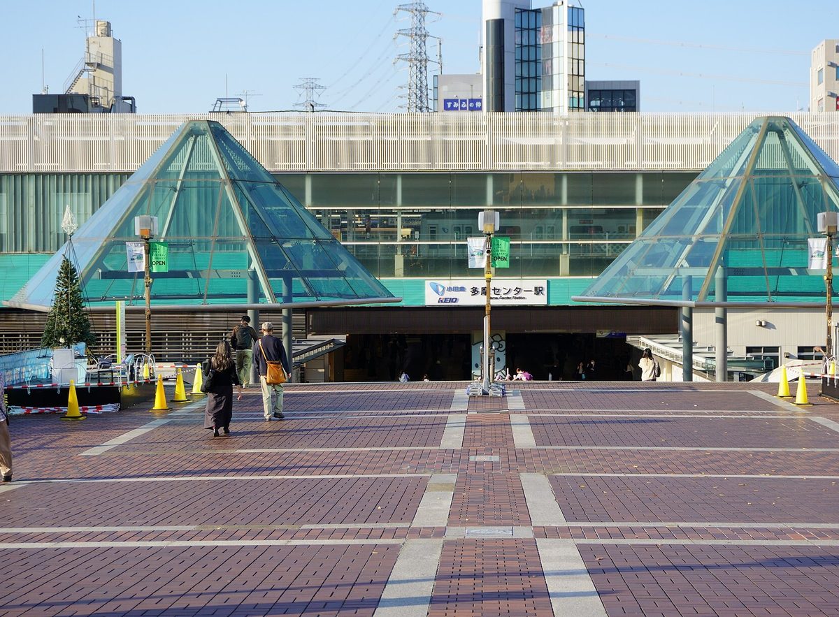 The wide brick plaza in front of Tama Center Station in Tama (Tokyo), with two glass pyramid roofs over the station entrance