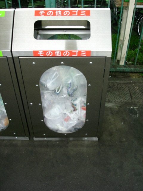 A see-through trash bin at a train station in Japan
