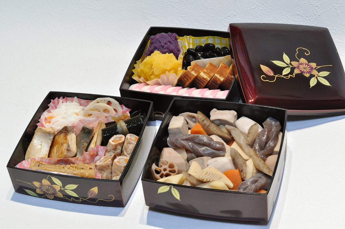Osechi New Year food in lacquered boxes, with black beans, rolled omelet, sweet mash and simmered vegetables