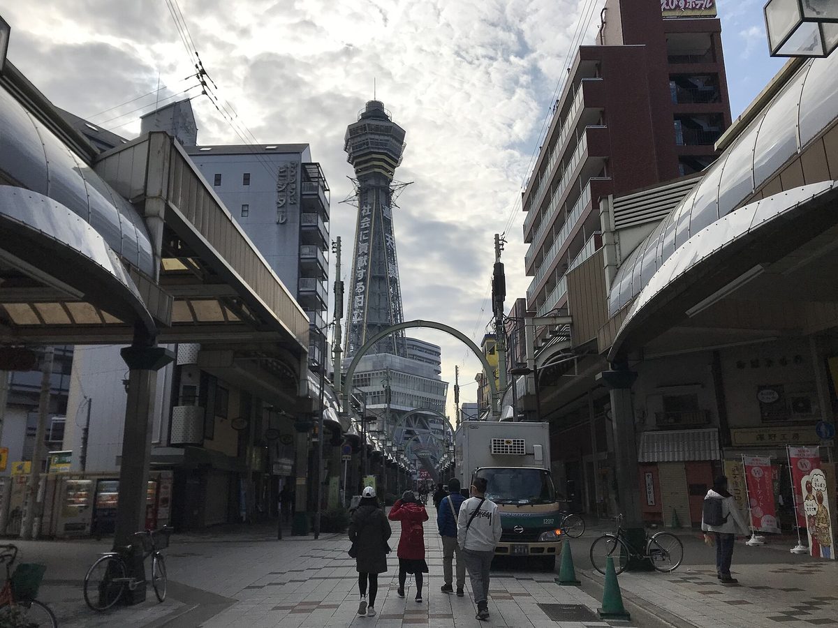 Tsutenkaku Tower seen at the end of a covered shopping street in Shinsekai, Osaka (Osaka)